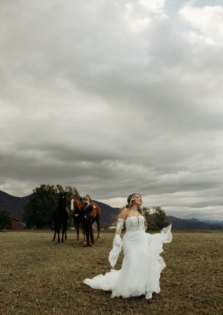 A gorgeous elopement in Glacier National Park with the couple posing with horses.