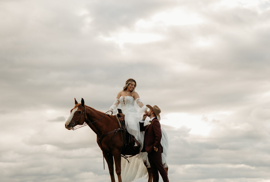 A gorgeous elopement in Glacier National Park with the couple posing with horses.