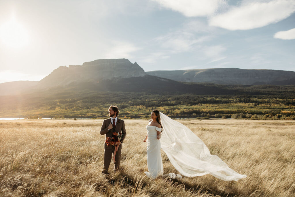 Two people sharing a special moment during their elopement session in the rugged beauty of Glacier National Park.
