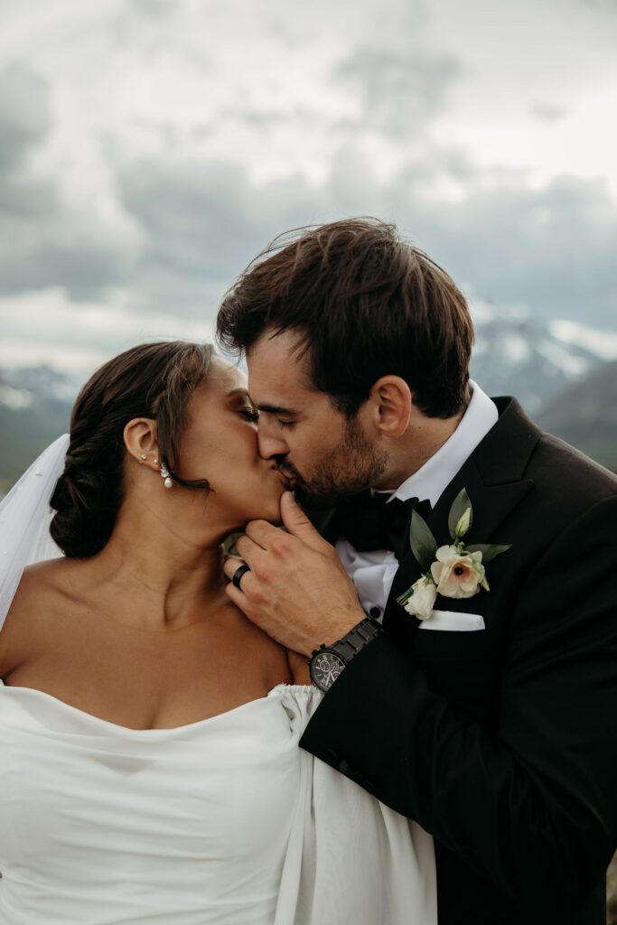 Two people sharing a special moment during their elopement session in the rugged beauty of Glacier National Park.