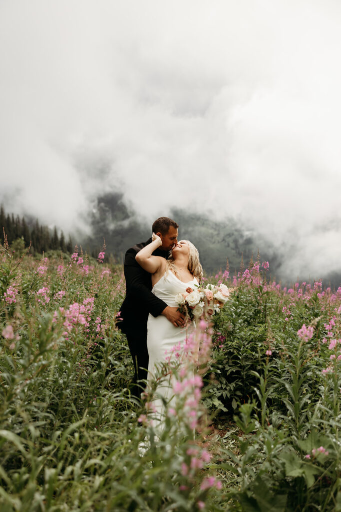 Bride and groom sharing a kiss with mountain views in Montana
