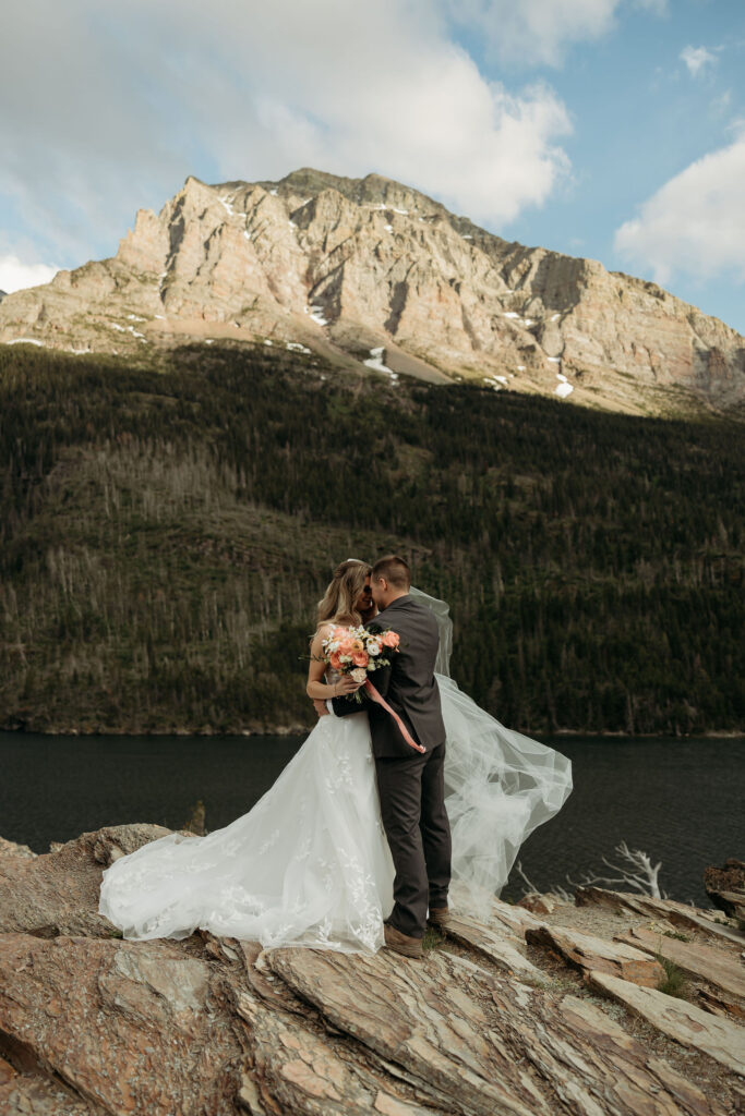 Couple walking hand-in-hand after getting married in montana at sunset
