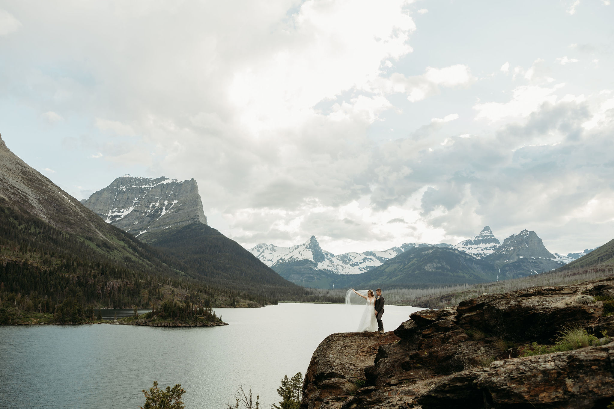 Bride and groom sharing a kiss with mountain views in Montana