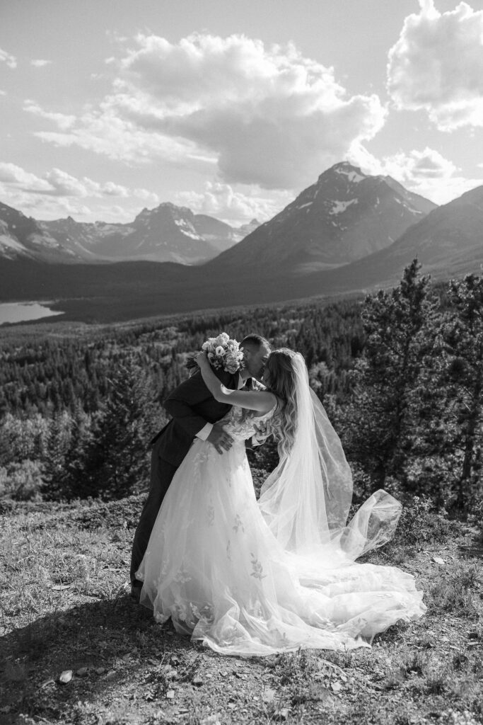 Bride and groom sharing a kiss with mountain views in Montana

