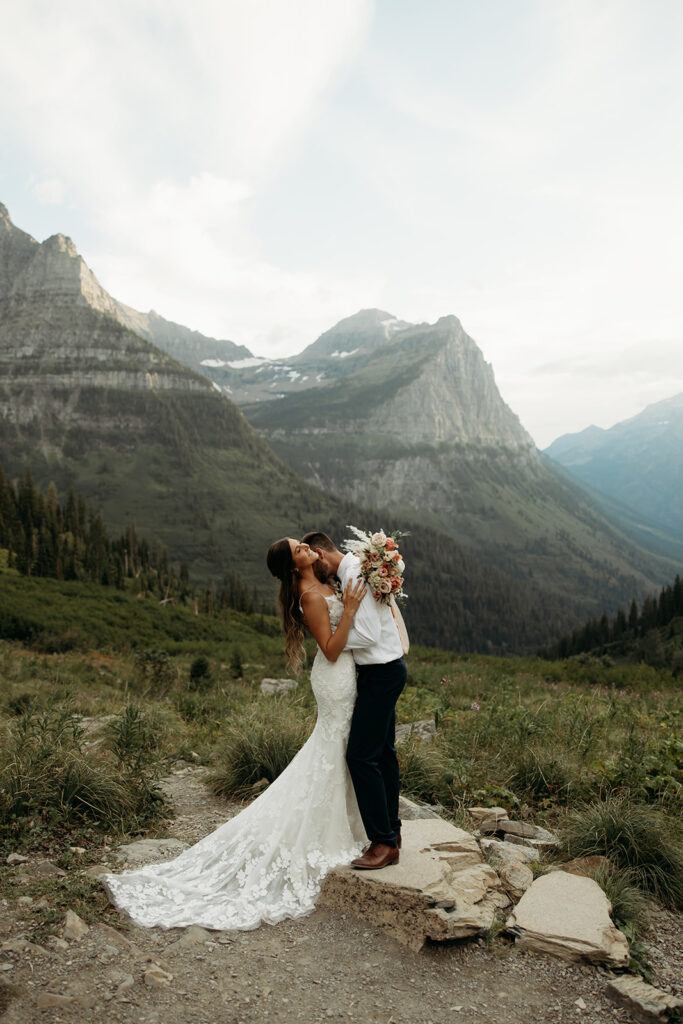 Couple eloping in Glacier National Park with mountain views in the background
