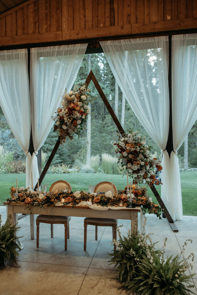 Montana wedding reception with a floral arch.