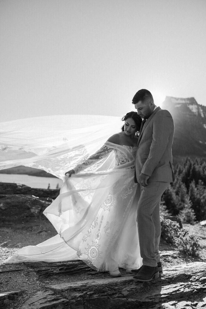 Couple eloping in Glacier National Park with mountain views in the background
