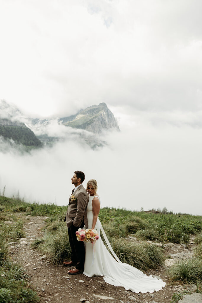 Bride and groom hiking together during their epic elopement