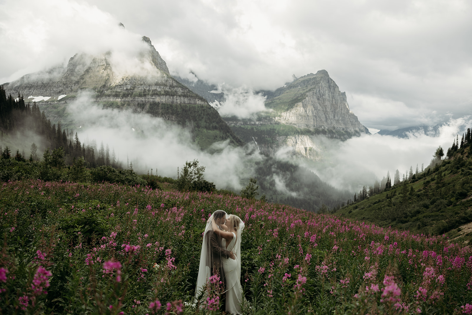 Couple eloping in Glacier National Park with mountain views in the background