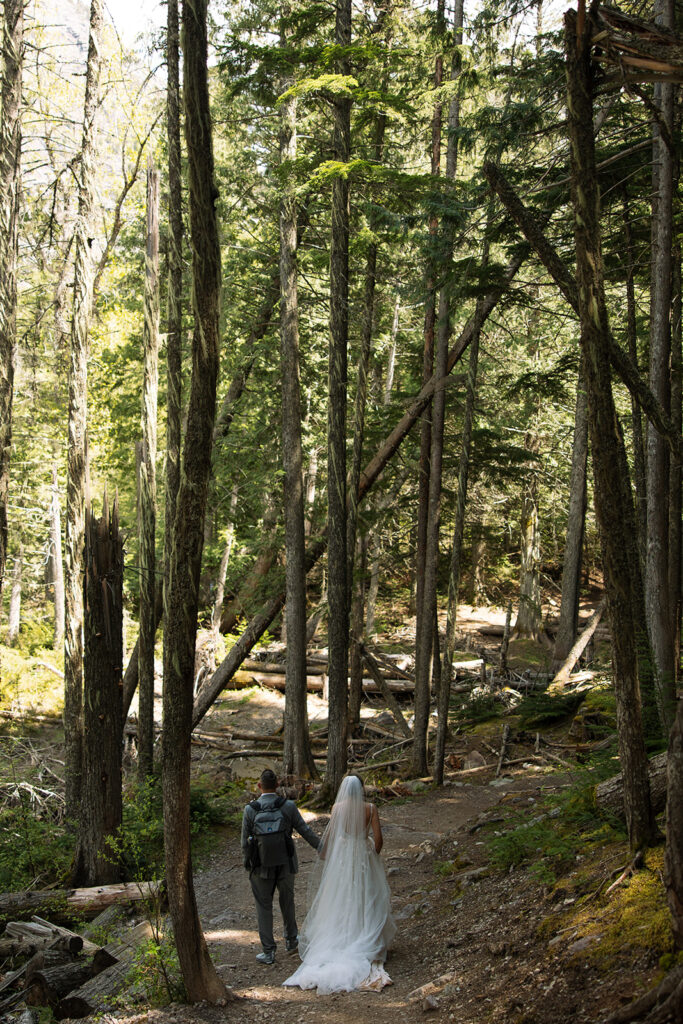 Couple sharing a candid moment during their adventure elopement in Glacier National Park
