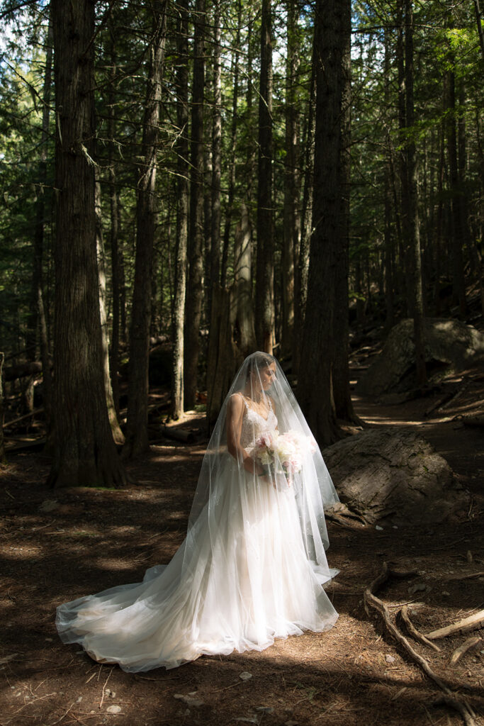 Bride and groom exploring the trails and natural beauty of Avalanche Lake
