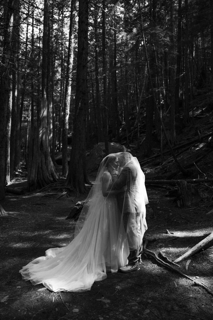 Bride and groom exploring the trails and natural beauty of Avalanche Lake
