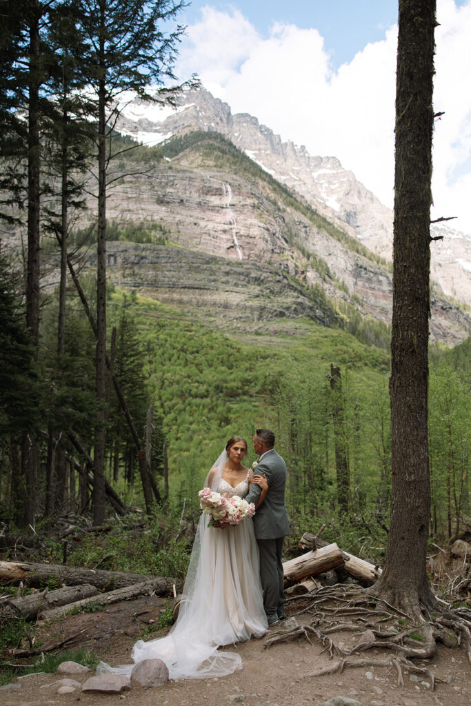 Bride and groom exploring the trails and natural beauty of Avalanche Lake
