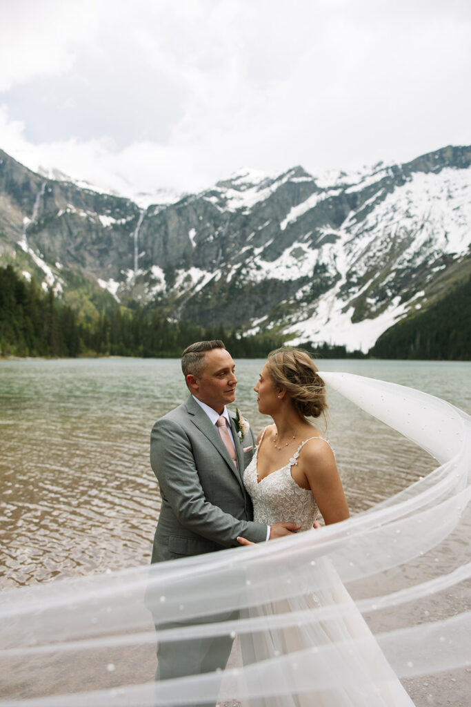 Couple sharing a candid moment during their adventure elopement in Glacier National Park
