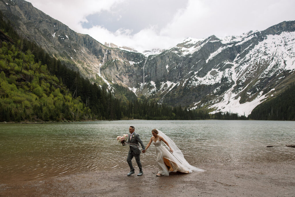 Couple sharing a candid moment during their adventure elopement in Glacier National Park
