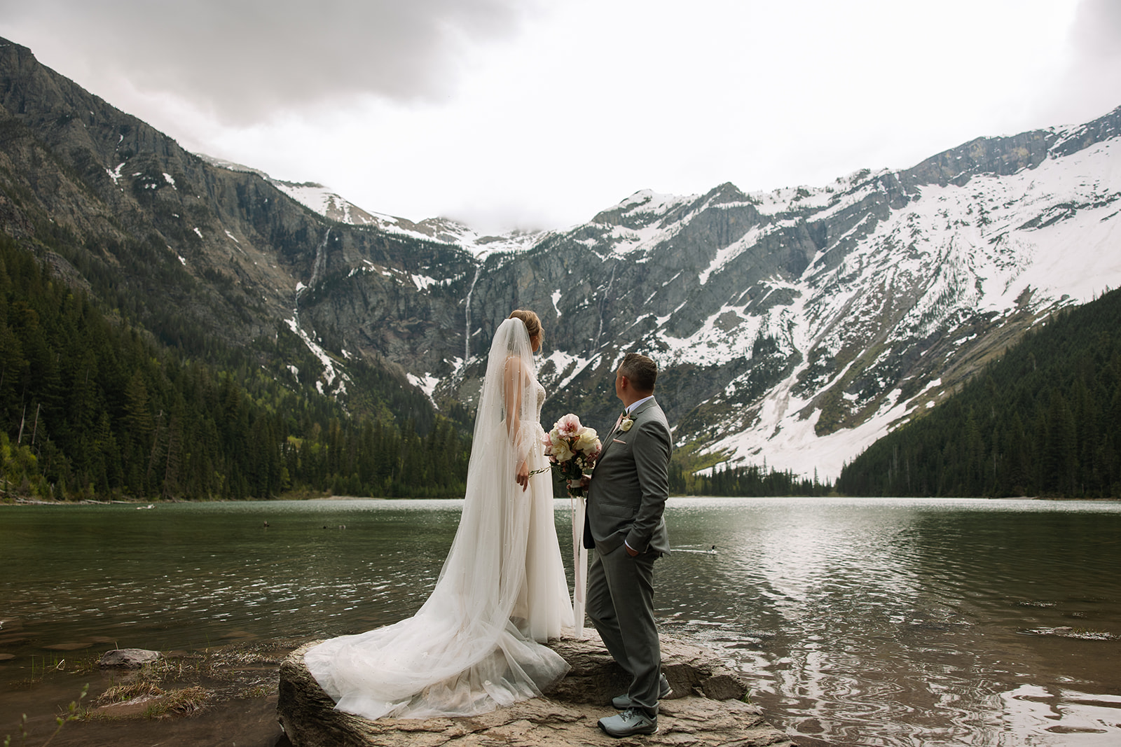 Couple sharing a candid moment during their adventure elopement in Glacier National Park