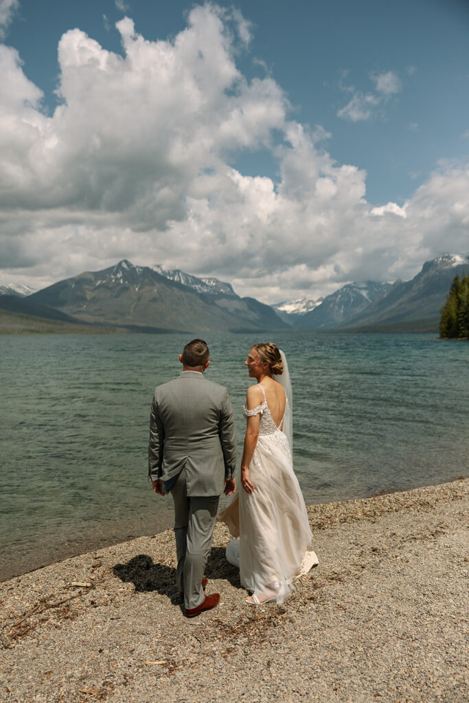 Couple sharing a candid moment during their adventure elopement in Glacier National Park