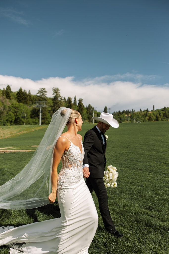Bride and groom sharing a candid moment during their upscale western wedding celebration.
