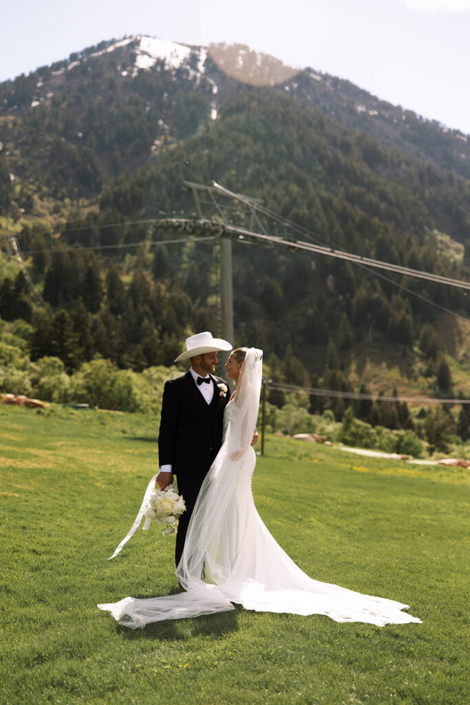 A couple celebrating their luxury western wedding with mountain views in the background.
