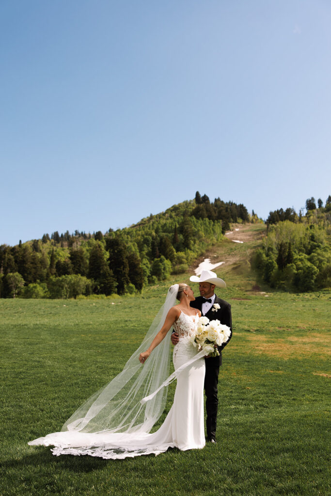 Bride and groom sharing a candid moment during their upscale western wedding celebration.
