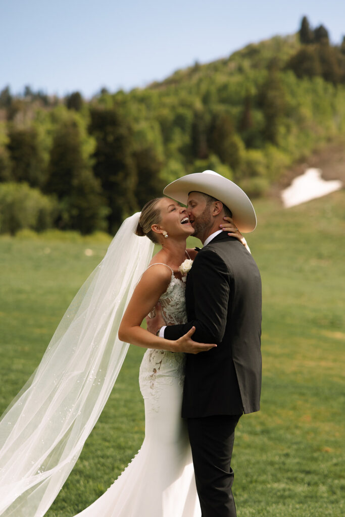 Bride and groom sharing a candid moment during their upscale western wedding celebration.
