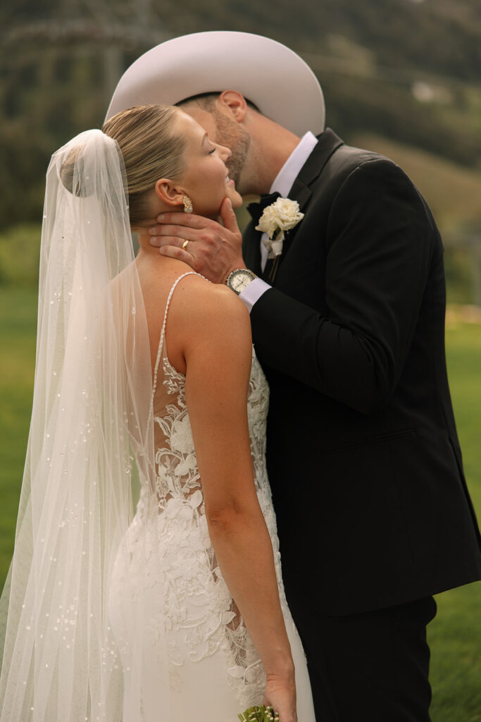A couple celebrating their luxury western wedding with mountain views in the background.

