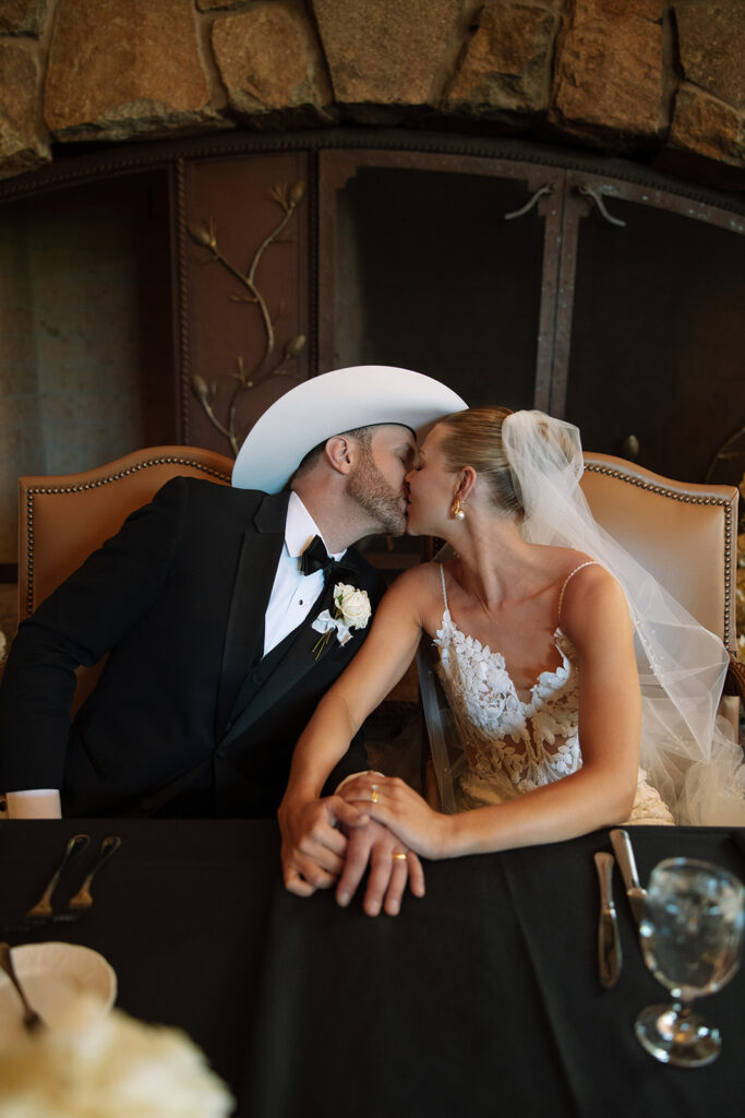 Timeless wedding moment captured in the mountains with elegant western details.
