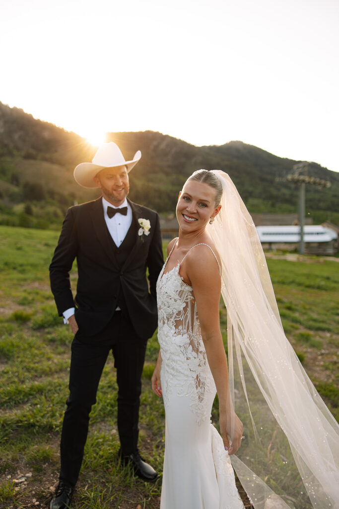 Bride and groom sharing a candid moment during their upscale western wedding celebration.

