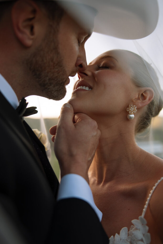 A couple celebrating their luxury western wedding with mountain views in the background.
