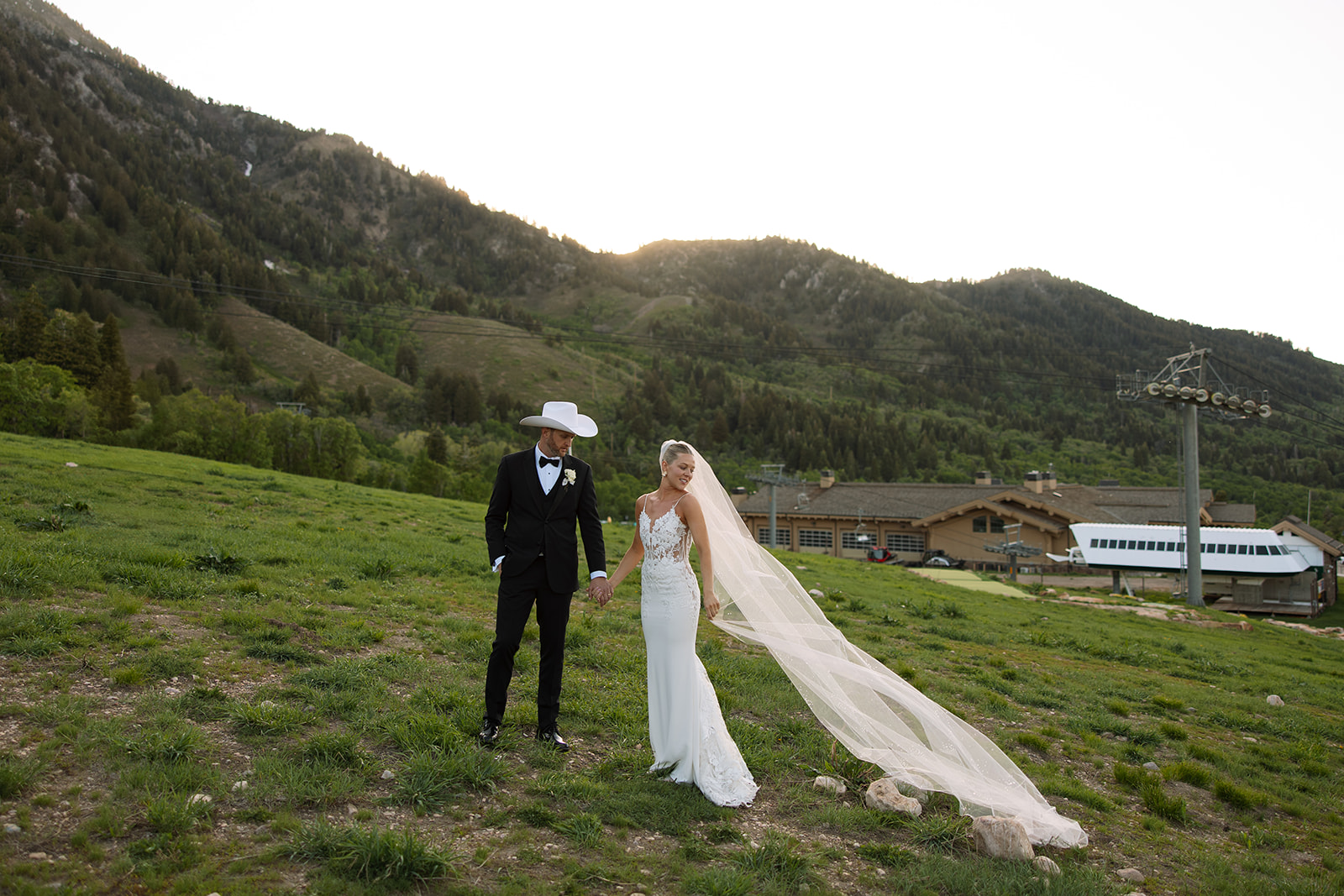 A couple celebrating their luxury western wedding with mountain views in the background.