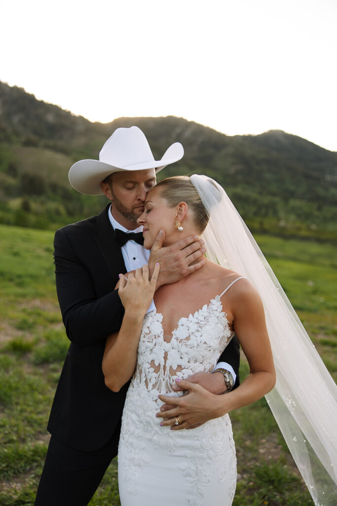 Bride and groom sharing a candid moment during their upscale western wedding celebration.
