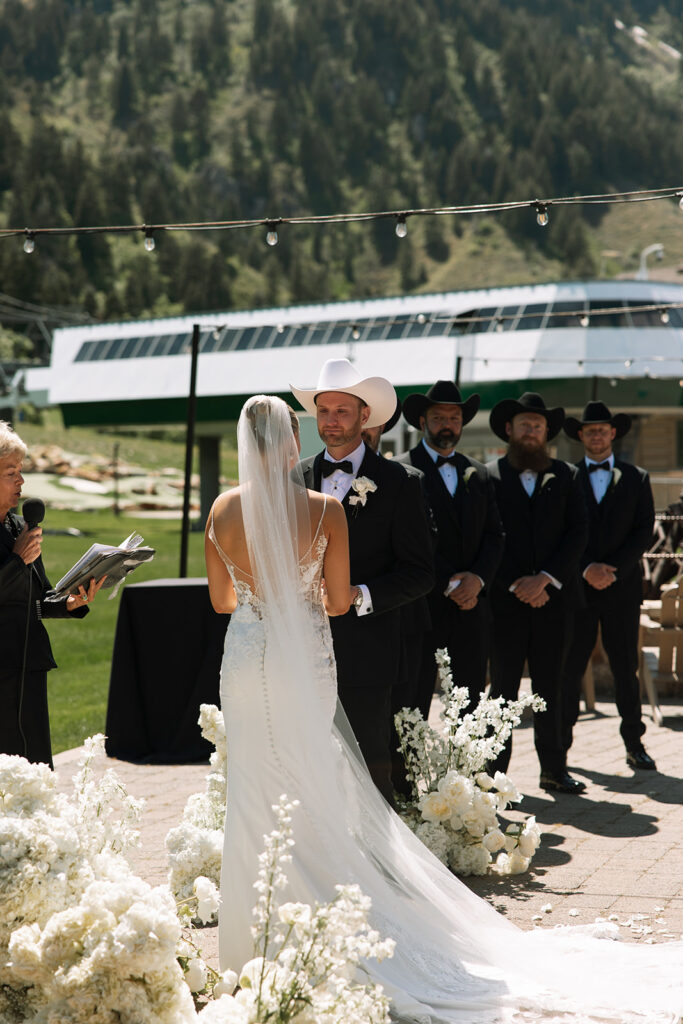 Bride and groom sharing a candid moment during their upscale western wedding celebration.
