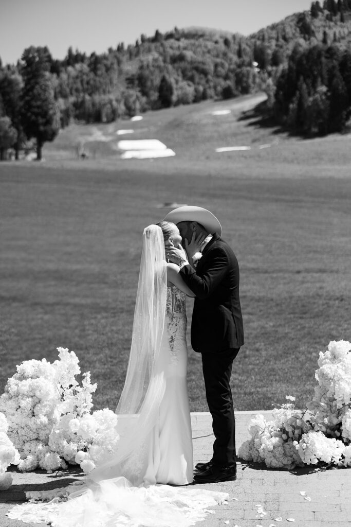 Timeless wedding moment captured in the mountains with elegant western details.