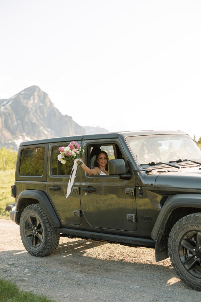 Newlyweds riding in a jeep after their cut bank montana wedding