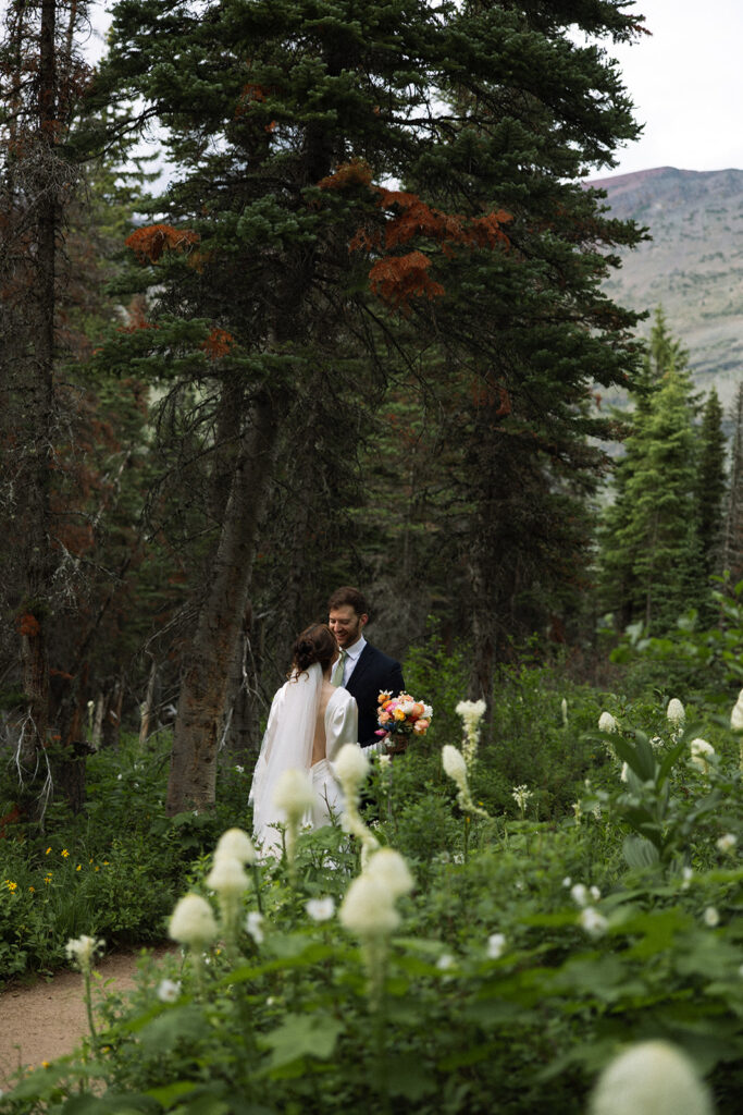 Bride and groom sharing a quiet moment during their Many Glacier elopement.

