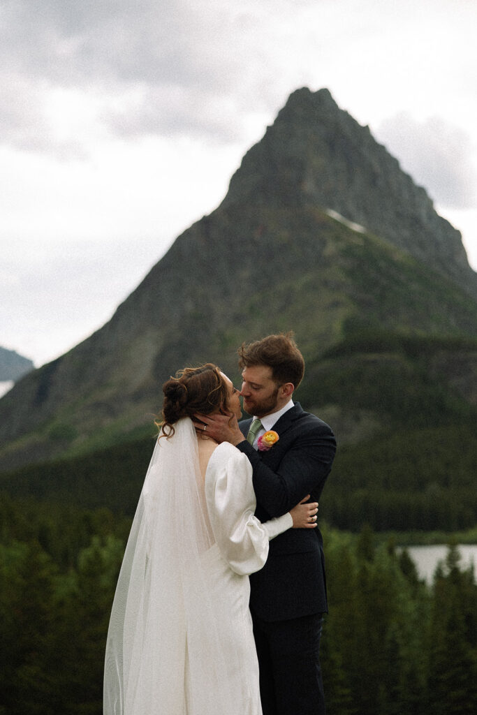 Couple walking through wildflowers at Many Glacier in Glacier National Park.
