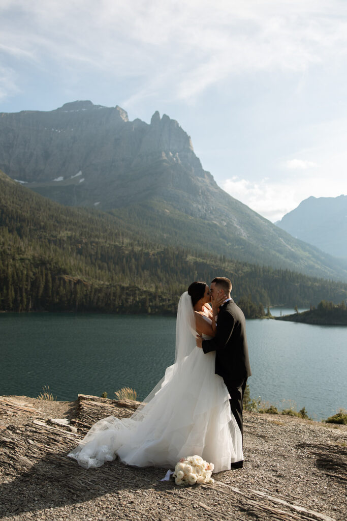 Bride and groom holding hands during their Sun Point ceremony in Glacier National Park
