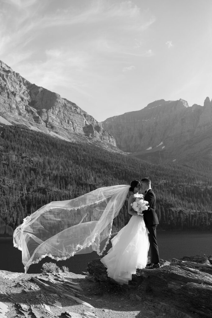 Bride and groom holding hands during their Sun Point ceremony in Glacier National Park

