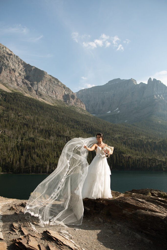 Bride and groom holding hands during their Sun Point ceremony in Glacier National Park
