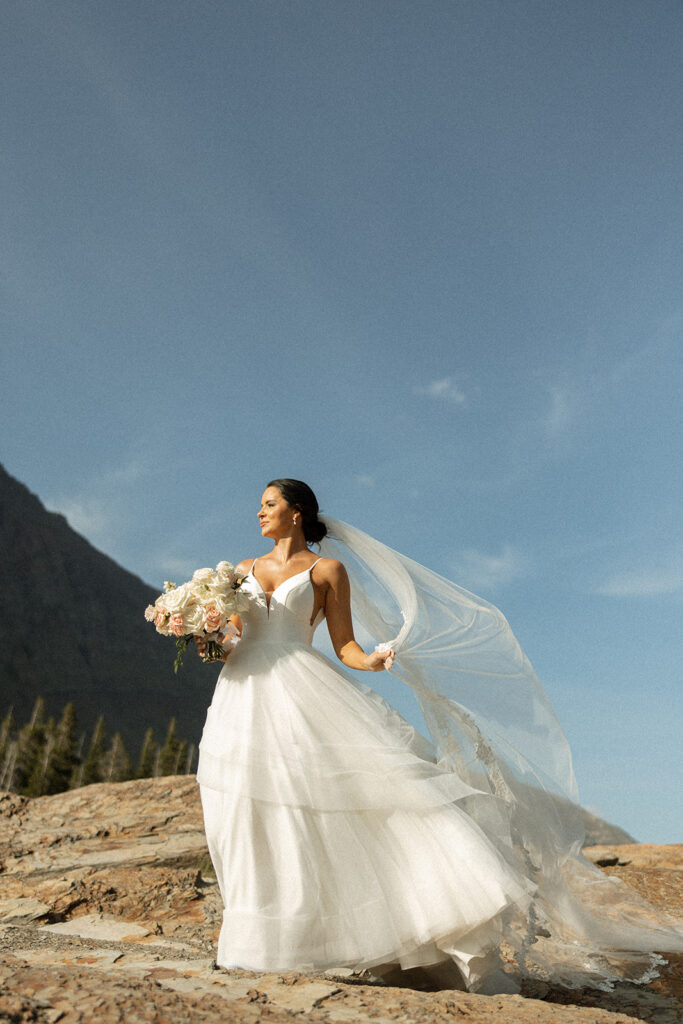 Bride and groom holding hands during their Sun Point ceremony in Glacier National Park
