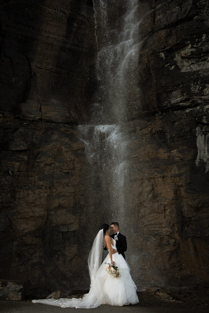 Newlyweds walking along a scenic overlook on Going to the Sun Road