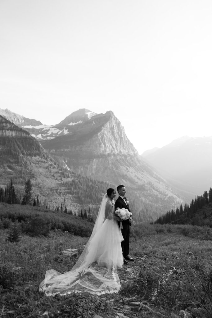 Bride and groom embracing at Big Bend during golden hour in Glacier National Park
