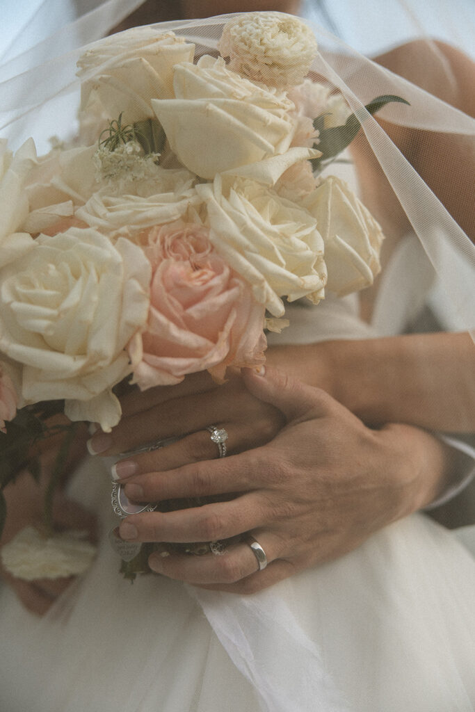 Bride and groom holding hands during their Sun Point ceremony in Glacier National Park
