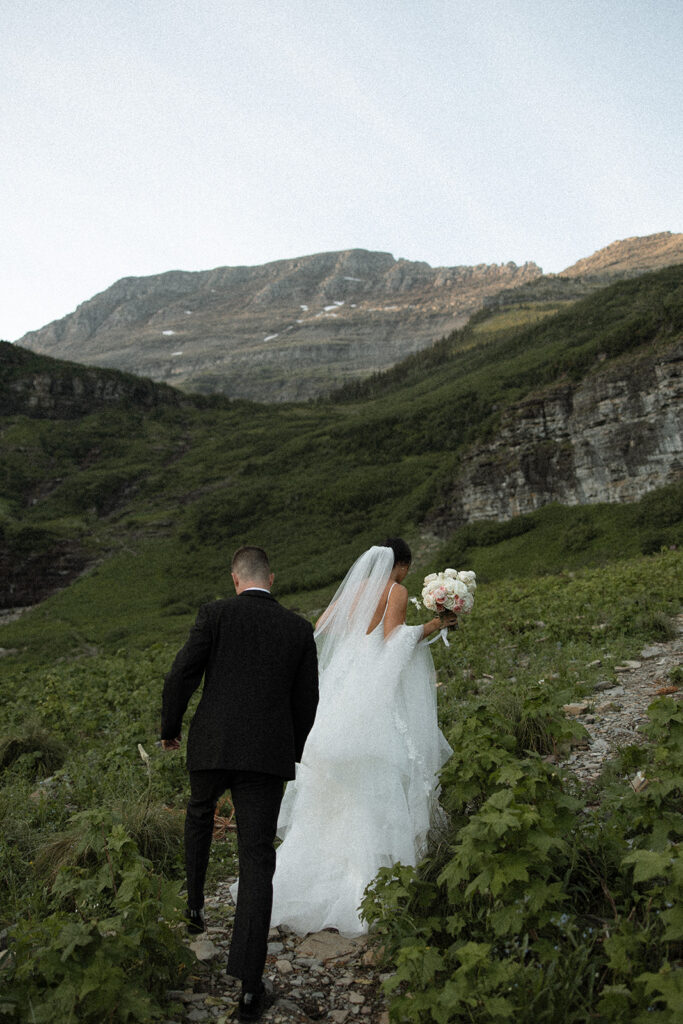 Bride and groom embracing at Big Bend during golden hour in Glacier National Park