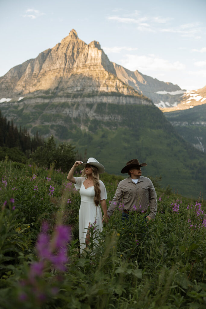 Candid photo of an engaged couple sharing a laugh against the backdrop of Glacier’s peaks.
