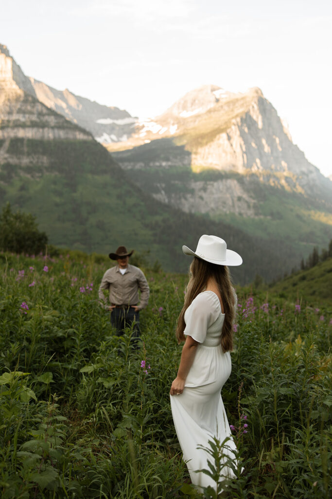 Engagement adventure session capturing a couple enjoying the morning light in Glacier National Park.
