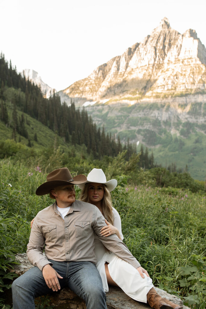 Engagement adventure session capturing a couple enjoying the morning light in Glacier National Park.

