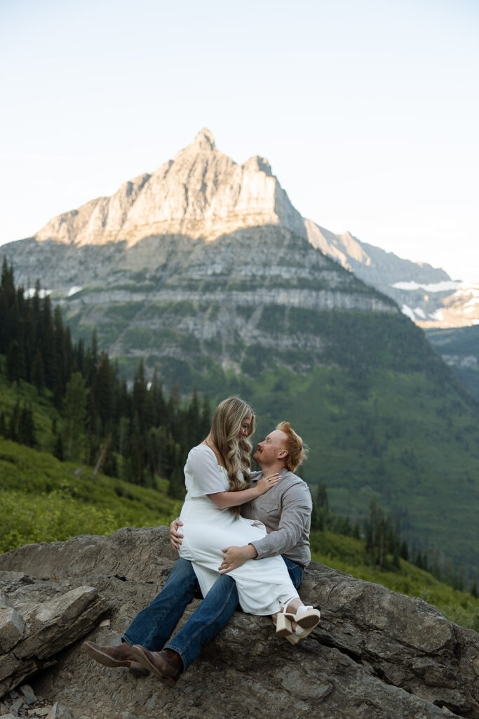 Romantic moment of a couple holding hands while walking along the trails in Glacier National Park.

