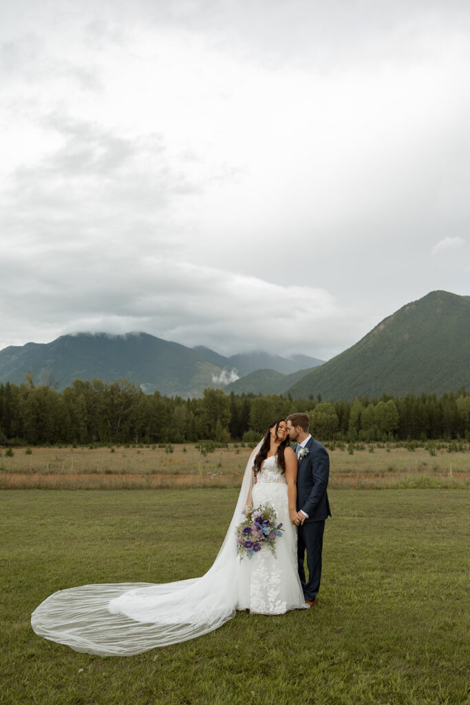 Bride and groom sharing a candid moment during their Montana wedding day
