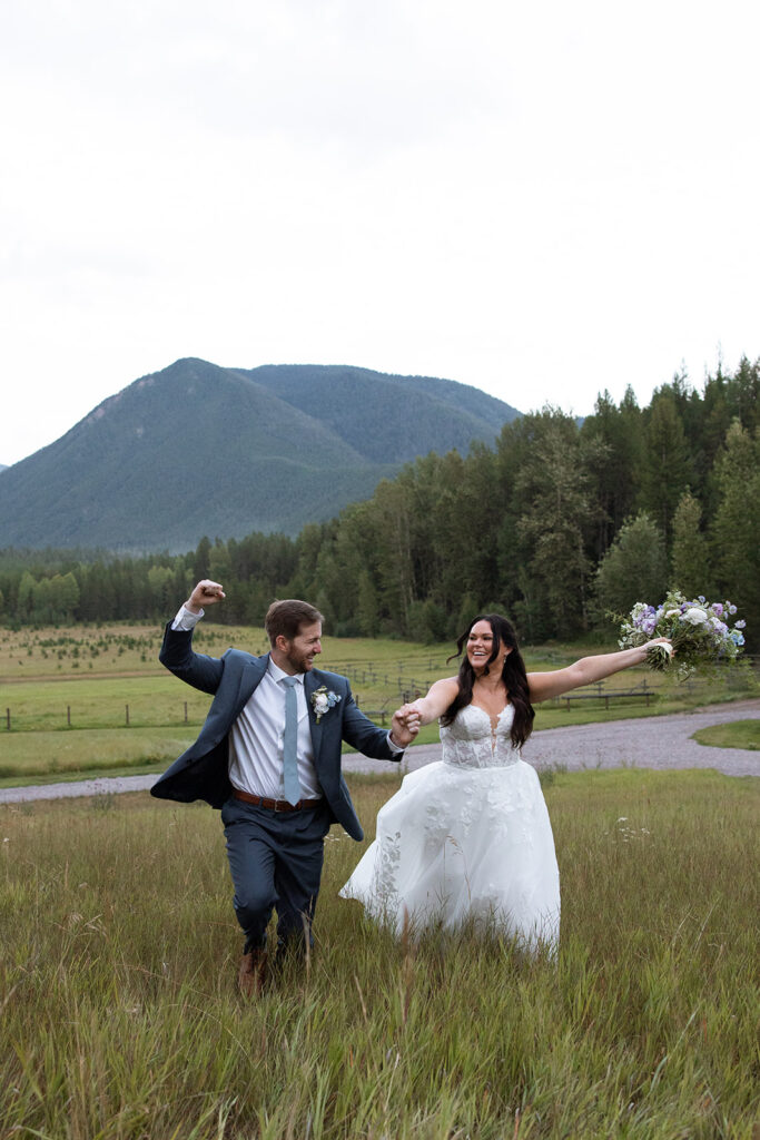 Couple walking hand in hand through wide open Montana fields